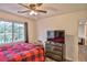This bedroom offers natural light from the windows, ceiling fan, and storage at 6739 Twisted Wood Dr, Las Vegas, NV 89148