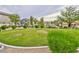 Landscaped community green space with lush grass, trees, and walkways for residents to enjoy at 6739 Twisted Wood Dr, Las Vegas, NV 89148