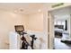 Upstairs exercise area featuring stationary bike and a view into a bedroom at 6739 Twisted Wood Dr, Las Vegas, NV 89148