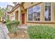 A sun-washed exterior, with manicured shrubs, leading to a warm and inviting front entrance at 6739 Twisted Wood Dr, Las Vegas, NV 89148