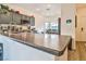 Granite countertop, stainless steel appliances and view to dining area at 6739 Twisted Wood Dr, Las Vegas, NV 89148