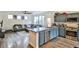 Open-concept kitchen and living room featuring stainless steel appliances, modern cabinets, and wood flooring at 6739 Twisted Wood Dr, Las Vegas, NV 89148