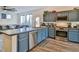 Open-concept kitchen and living room featuring stainless steel appliances, modern cabinets, and wood flooring at 6739 Twisted Wood Dr, Las Vegas, NV 89148