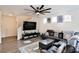 A stylish living room with a modern ceiling fan, television, and comfortable leather seating at 6739 Twisted Wood Dr, Las Vegas, NV 89148