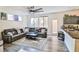 Open-concept living room with a large sectional sofa, a ceiling fan and easy access to the kitchen at 6739 Twisted Wood Dr, Las Vegas, NV 89148
