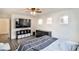 Upstairs main bedroom with hardwood-style floors, ceiling fan, and large windows at 6739 Twisted Wood Dr, Las Vegas, NV 89148