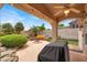 Backyard patio and fire pit area with a ceiling fan and lush landscaping at 7511 Bridlehorne Ave, Las Vegas, NV 89131