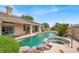 Backyard features a sparkling pool and spa surrounded by a patio and lush greenery at 7511 Bridlehorne Ave, Las Vegas, NV 89131
