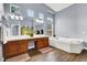 Bathroom featuring wood floors, double vanity, and soaking tub at 7511 Bridlehorne Ave, Las Vegas, NV 89131