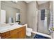 Bathroom featuring a shower, white sink, wood cabinets, and neutral wall coverings at 7511 Bridlehorne Ave, Las Vegas, NV 89131