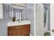 Bathroom with blue walls, wood vanity with white top, decorative vase and shower/tub combination at 7511 Bridlehorne Ave, Las Vegas, NV 89131