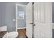 Bathroom featuring wood floors, double doors, and a toilet at 7511 Bridlehorne Ave, Las Vegas, NV 89131