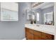 Cozy bathroom vanity with a white countertop and wooden cabinets at 7511 Bridlehorne Ave, Las Vegas, NV 89131