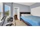 Bright bedroom featuring exercise equipment and an entrance to the ensuite bathroom at 7511 Bridlehorne Ave, Las Vegas, NV 89131