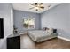 Bedroom with wood floors, ceiling fan, and natural light at 7511 Bridlehorne Ave, Las Vegas, NV 89131