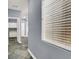 Hallway featuring diamond slate flooring and a sunlit window with horizontal blinds at 7511 Bridlehorne Ave, Las Vegas, NV 89131