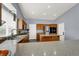 Well-lit kitchen featuring stone floors, stainless steel appliances, granite countertops, and wood cabinetry at 7511 Bridlehorne Ave, Las Vegas, NV 89131