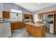 Bright kitchen with an island, stainless steel refrigerator, granite countertops, and ample cabinet space at 7511 Bridlehorne Ave, Las Vegas, NV 89131