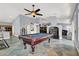Open living area showcasing a pool table, fireplace, custom tile flooring, and access to the kitchen at 7511 Bridlehorne Ave, Las Vegas, NV 89131