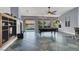 Living room featuring a pool table, large windows, access to backyard, and custom tile flooring at 7511 Bridlehorne Ave, Las Vegas, NV 89131