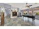 Open living area showcasing a fireplace, custom tile flooring, and a pool table at 7511 Bridlehorne Ave, Las Vegas, NV 89131