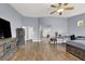 The main bedroom is large with wood floors, a ceiling fan, and views of the ensuite bathroom at 7511 Bridlehorne Ave, Las Vegas, NV 89131
