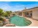 A gorgeous pool with a rock waterfall feature and inset dolphin tiles provides backyard fun at 7511 Bridlehorne Ave, Las Vegas, NV 89131