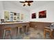 Chic wet bar featuring display shelving, decorative lighting, and seating for entertaining guests at 7511 Bridlehorne Ave, Las Vegas, NV 89131