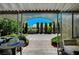 A covered patio leads to a private backyard with gravel, greenery, and a view of the neighborhood at 7625 Raven Hills Dr, Las Vegas, NV 89149