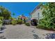 Spacious backyard with gravel, mature trees, and a covered patio; perfect for relaxation and entertaining at 7625 Raven Hills Dr, Las Vegas, NV 89149