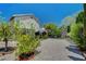 Spacious backyard with gravel, mature trees, and a view of the house; perfect for outdoor living at 7625 Raven Hills Dr, Las Vegas, NV 89149