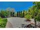 A gravel backyard with lush trees and greenery creates a private and serene outdoor space at 7625 Raven Hills Dr, Las Vegas, NV 89149