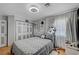 Bedroom with a ceiling fan, closet and a queen size bed with grey patterned bedding at 7625 Raven Hills Dr, Las Vegas, NV 89149