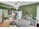 Bedroom with green accent wall, overhead lighting, and patterned bedding at 7625 Raven Hills Dr, Las Vegas, NV 89149