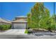 Charming home featuring a two-car garage, well-manicured lawn and desert landscaping at 7625 Raven Hills Dr, Las Vegas, NV 89149