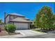 Charming two-story home boasting a tile roof, a three-car garage and mature landscaping at 7625 Raven Hills Dr, Las Vegas, NV 89149