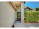 Welcoming front entrance features a security screen door and attractive landscaping for curb appeal at 7625 Raven Hills Dr, Las Vegas, NV 89149