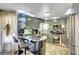 Modern kitchen featuring gray cabinets, stainless steel appliances, and a breakfast bar with a marble countertop at 7625 Raven Hills Dr, Las Vegas, NV 89149