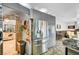 Spacious kitchen featuring stainless steel refrigerator and modern cabinetry with view into dining area at 7625 Raven Hills Dr, Las Vegas, NV 89149