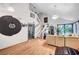 Spacious living room with wood floors, an open staircase, and stylish decor at 7625 Raven Hills Dr, Las Vegas, NV 89149