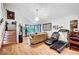Bright living room with wood floors, high ceilings, and an open staircase, creating an inviting space at 7625 Raven Hills Dr, Las Vegas, NV 89149