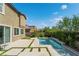Private backyard featuring a pool with a waterfall feature, patio and mature landscaping at 7732 Bandon Cliffs St, North Las Vegas, NV 89084