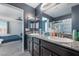 Bathroom boasts dual sinks, granite counters, dark wood cabinets, and glass shower, adjacent to the bedroom at 7732 Bandon Cliffs St, North Las Vegas, NV 89084