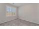 Cozy bedroom with gray carpet and plantation shutters offering natural light at 7732 Bandon Cliffs St, North Las Vegas, NV 89084