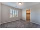 Bedroom with gray carpet, plantation shutters, and open door to closet at 7732 Bandon Cliffs St, North Las Vegas, NV 89084