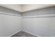 Walk-in closet with simple wooden shelving along the perimeter for efficient organization at 7732 Bandon Cliffs St, North Las Vegas, NV 89084