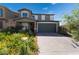 Charming two-story home with landscaped yard and brick driveway at 7732 Bandon Cliffs St, North Las Vegas, NV 89084