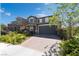Charming two-story home with landscaped yard and brick driveway at 7732 Bandon Cliffs St, North Las Vegas, NV 89084