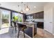 Modern kitchen with stainless appliances, granite countertops, and breakfast bar at 7732 Bandon Cliffs St, North Las Vegas, NV 89084