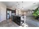 Modern kitchen with stainless appliances, granite countertops, and open layout at 7732 Bandon Cliffs St, North Las Vegas, NV 89084